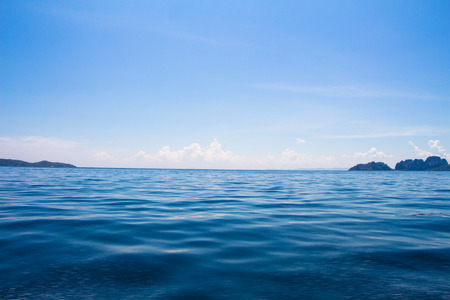 ocean surface and blue sky with cloudsの写真素材