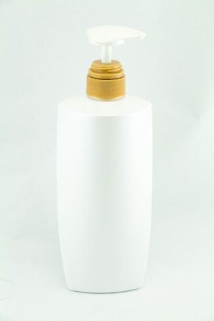 White plastic bottles for cosmetic creams, lotions, shampoo and gels with colored capsの写真素材