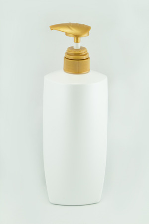 White plastic bottles for cosmetic creams, lotions, shampoo and gels with colored capsの写真素材