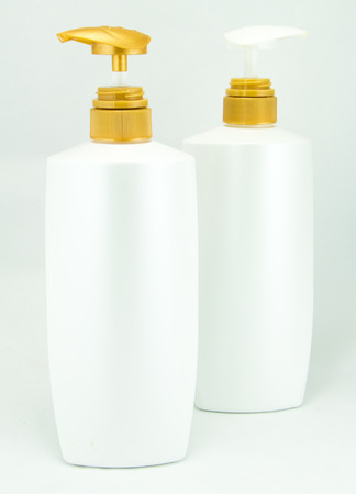 White plastic bottles for cosmetic creams, lotions, shampoo and gels with colored capsの写真素材