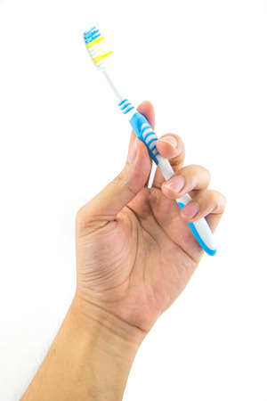 Men hand holding toothbrush isolated on whiteの写真素材