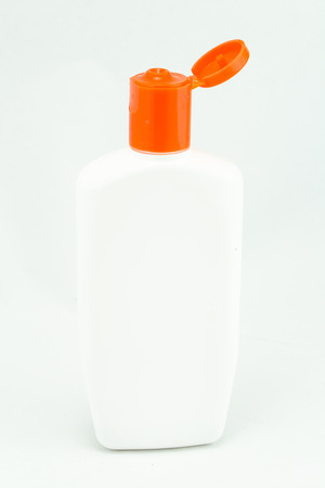White plastic bottles for cosmetic creams, lotions, shampoo and gels with colored capsの写真素材