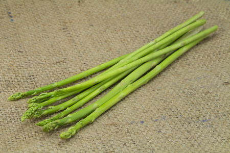 Organic Asparagus on sack backgroundの写真素材