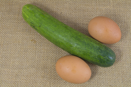 cucumber and egg look like penis on sackの写真素材