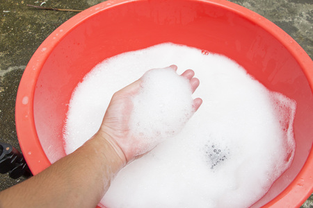 Hand washing clothes with soapy waterの写真素材