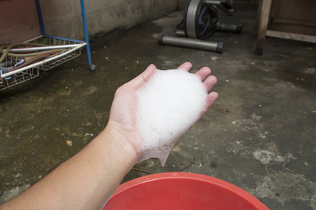 Hand washing clothes with soapy waterの写真素材