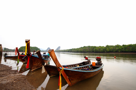  Long-tail boat parked at the shore waiting for touristsの写真素材