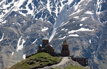 Gergeti Trinity Church and Caucasus Mountains, near Stepantsminda (formerly Kazbegi). Georgia.の写真素材