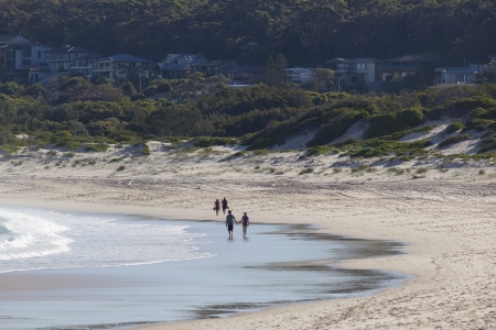 Two couples walk on a beach  Fingal Bay  Port Stephens  Australia の写真素材