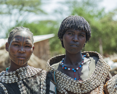 WEITA. OMO VALLEY. ETHIOPIA - DECEMBER 29, 2013: Traditionally dressed unidentified women from Tsemay tribe. Most Omo Valley people maintain their traditional way of life.のeditorial素材