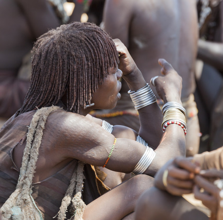 TURMI, OMO VALLEY, ETHIOPIA - DECEMBER 30, 2013: Unidentified Hamar women at village market. Weekly markets are important events in Omo Valley tribal life.のeditorial素材