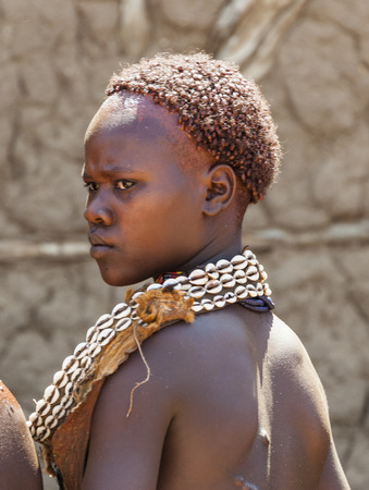 TURMI, OMO VALLEY, ETHIOPIA - DECEMBER 30, 2013: Unidentified Hamar woman at village market. Weekly markets are important events in Omo Valley tribal life.のeditorial素材
