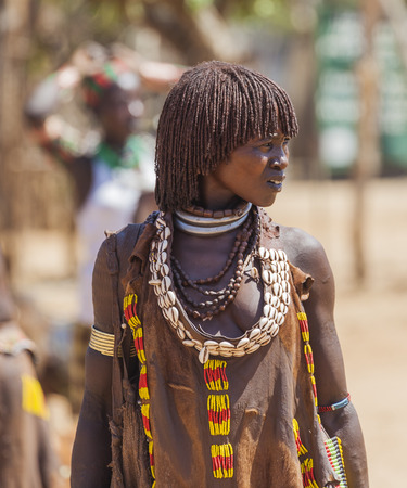 TURMI, OMO VALLEY, ETHIOPIA - DECEMBER 30, 2013: Unidentified Hamar woman at village market. Weekly markets are important events in Omo Valley tribal life.のeditorial素材