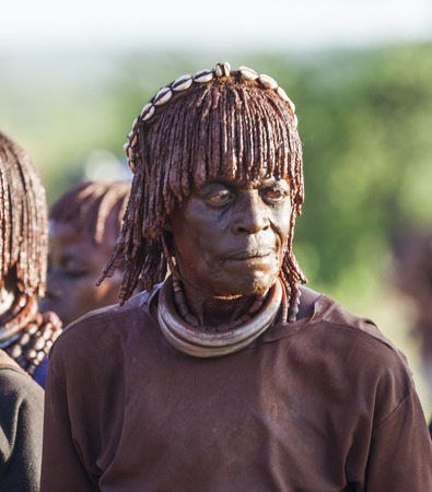 TURMI, OMO VALLEY, ETHIOPIA - DECEMBER 30, 2013: Portrait of unidentified mature Hamar woman at bull jumping ceremony. Jumping of the bull is a rite of passage into manhood in some Omo Valley tribes.のeditorial素材