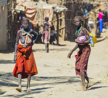 OMORATO, LOWER OMO VALLEY, ETHIOPIA - JANUARY 31, 2012: Unidentified people on the street in traditional village of Dassanech tribe.  Omorato one of the poorest places in Ethiopia.のeditorial素材
