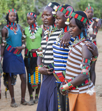 TURMI, OMO VALLEY, ETHIOPIA - DECEMBER 30, 2013: Unidentified young boys and girls gearing at the traditional evangaty (night dance) ceremony.のeditorial素材