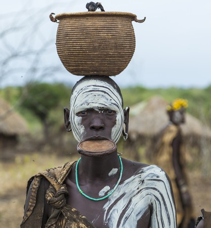 MAGO NATIONAL PARK OMO VALLEY ETHIOPIA  JANUARY 01 2014: Unidentified Woman from Mursi tribe in Mirobey village. Mursi woman are famous for their traditional lip plateのeditorial素材