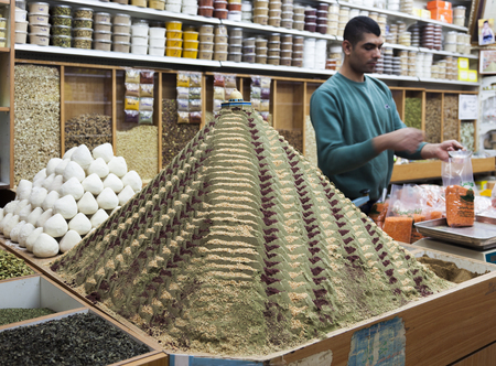JERUSALEM OLD TOWN, ISRAEL - NOVEMBER 1, 2014: unidentified seller in Spices shop on Beit HaBad Street.のeditorial素材