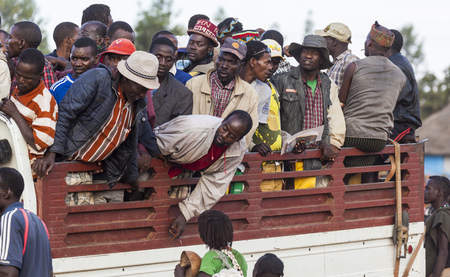 KEY AFAR VILLAGE, OMO VALLEY. ETHIOPIA - JANUARY 2, 2014: Unidentified Banna man at back of a truck leaving market in the evening.のeditorial素材