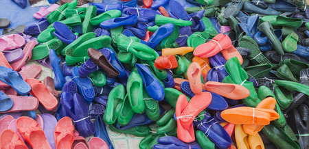 BONATA VILLAGE, OMO VALLEY. ETHIOPIA - JANUARY 2, 2014: Cheap multi-coloured rubber shoes for sale on local market. They are very populate in Ethiopiaのeditorial素材