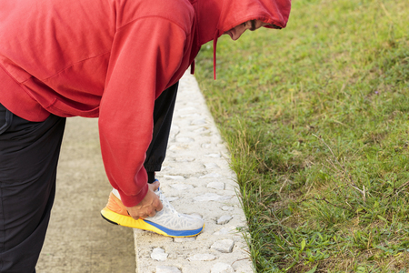 Man Tying up a Jogging Shoe