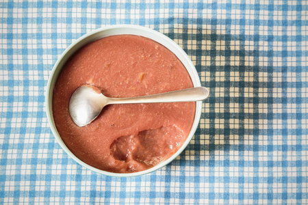 Bowl of smooth chocolate milk pudding on the desk shot from directly above