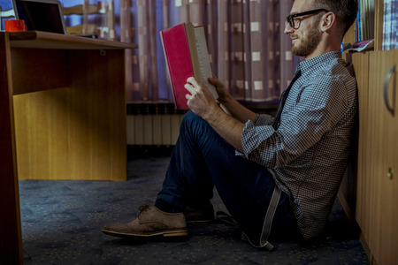 Student working hard over night in libraryの写真素材