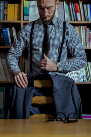 Handsome man portrait at office library. Man is wearing casual smart clothing and modern suit.の写真素材