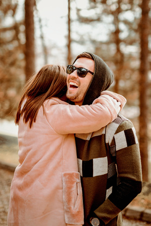 Young Beautiful Couple heaving fun outdoors at park in nature. Nice atmosphere with full of love.の写真素材