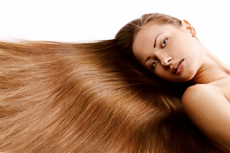young beautiful girl with beautiful long brown healthy shiny hairの写真素材