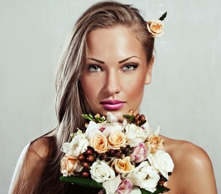 young beautiful woman with flowers , glamour makeup , make-up , perfect clean skin , long hairの写真素材