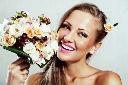 young beautiful woman with flowers , glamour makeup , make-up , perfect clean skin , long hairの写真素材
