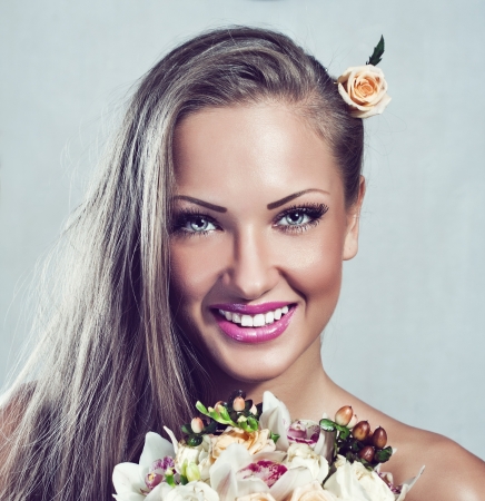 young beautiful woman with flowers , glamour makeup , make-up , perfect clean skin , long hairの写真素材