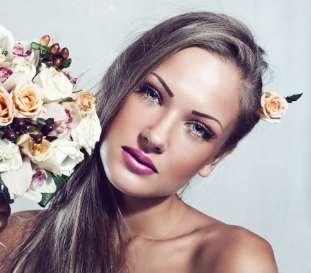 young beautiful woman with flowers , glamour makeup , make-up , perfect clean skin , long hairの写真素材