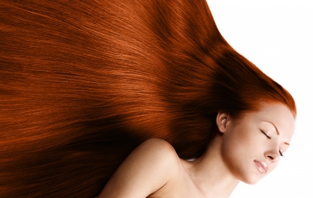 closeup portrait of a beautiful young woman with elegant long red shiny hair , hairstyle , isolated on white background , healthy straight hairの写真素材