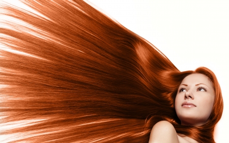 closeup portrait of a beautiful young woman with elegant long red shiny hair , hairstyle , isolated on white background , healthy straight hairの写真素材