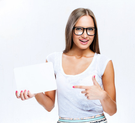 young smiling woman holding blank business cardの写真素材