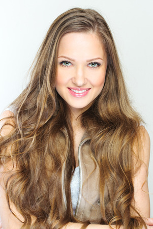 Beautiful young woman with long curly hairsの写真素材