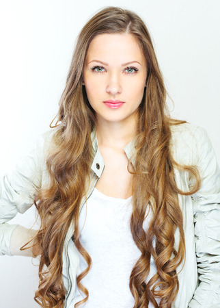 Beautiful young woman with long curly hairsの写真素材