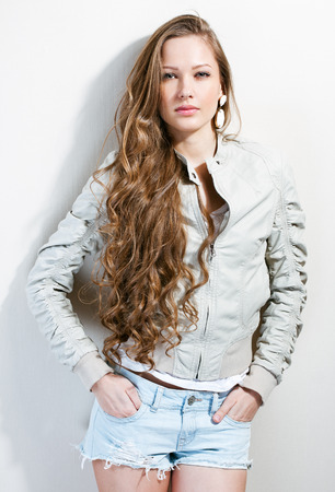 portrait of a beautiful young brunette girl dressed trendy  fashionの写真素材
