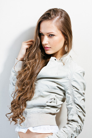 portrait of a beautiful young brunette girl dressed trendy  fashionの写真素材