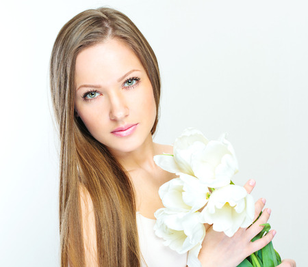 Portrait of a beautiful woman with flowers の写真素材
