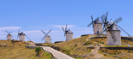 old white windmills in a row in Consuega, Spainの写真素材