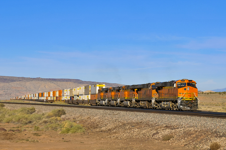 freight train with four locomotives and waggons full of containers in the desert, Arizona, USAの写真素材