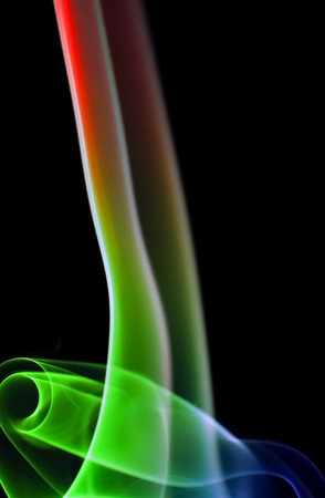 Colored smoke isolated on black backgroundの写真素材