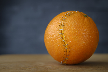 orange with stainless steel stitches that hold the husk togetherの写真素材