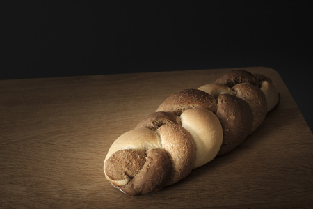 3 kinds interwoven bread lying on a wooden tableの写真素材