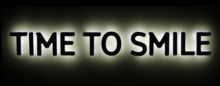 Background illuminated letters with text, time to smileの写真素材