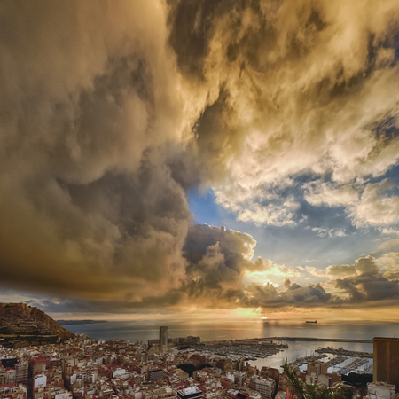 sunrise over the ancient city of Alicante in Spain and in the background the castle and harborの写真素材