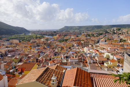 panoramic view over the colored houses with orange roofs in bosa sardinia italyの写真素材